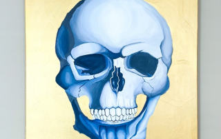 Painted blue skull on a shiny gold background