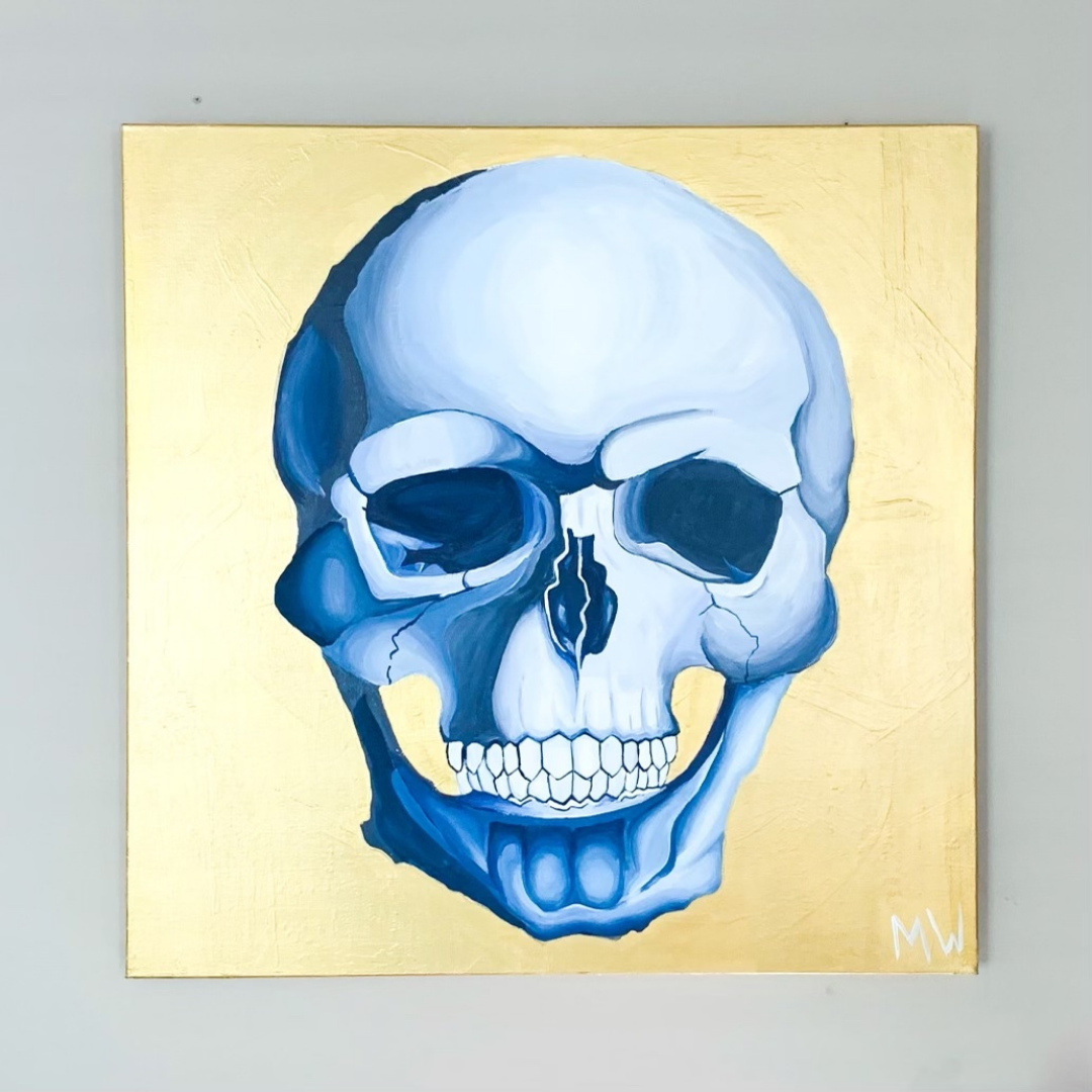 Painted blue skull on a shiny gold background